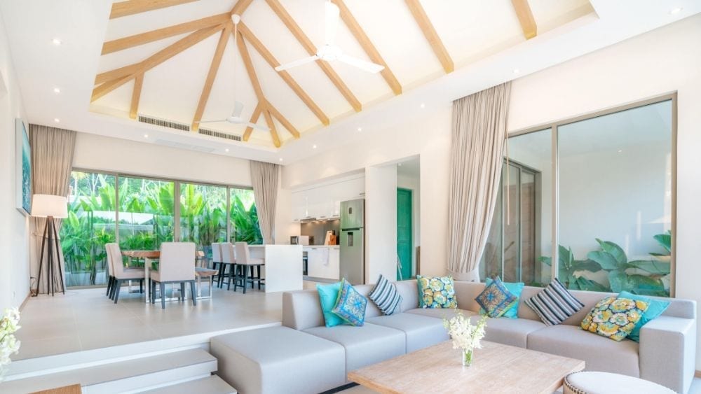 A cape-cod style living room with cathedral ceilings and lots of windows.