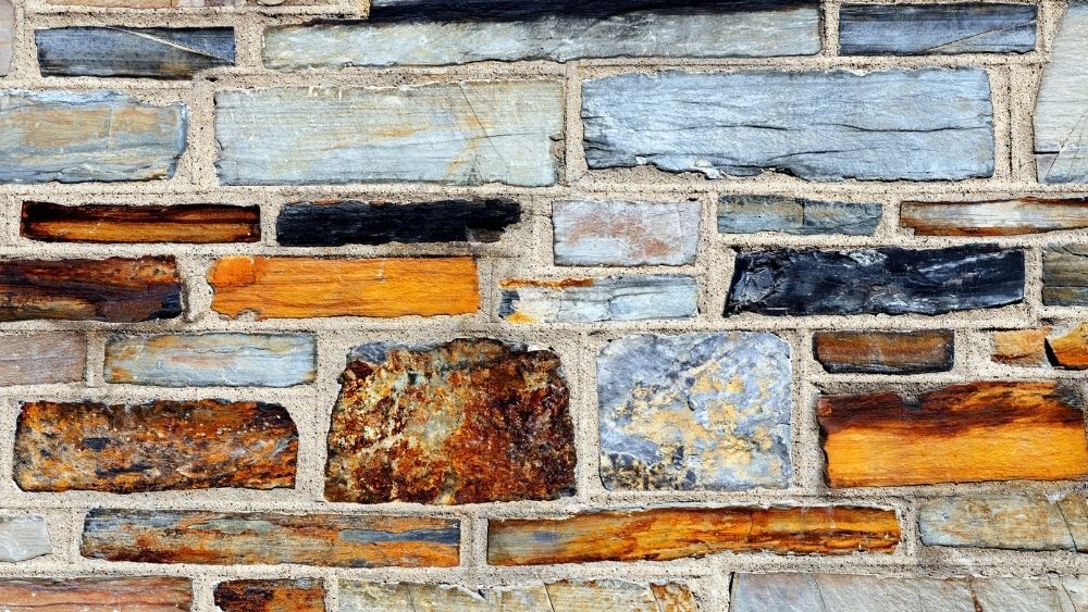 Sandstone layered into a wall with mortar.
