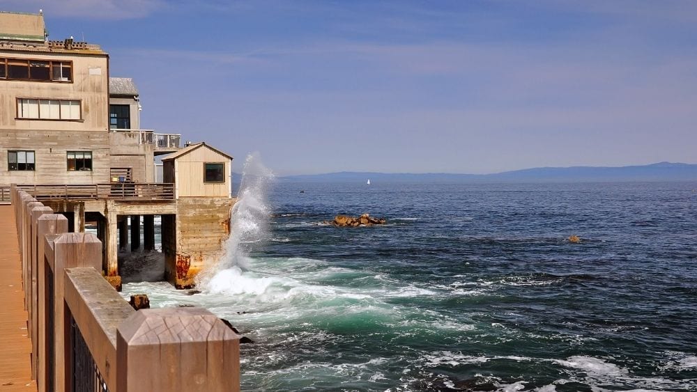 A coastal city with waves crashing against the shore.