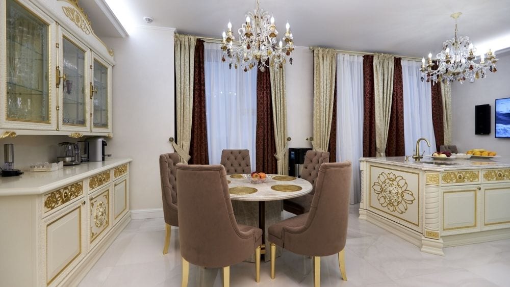 A luxury kitchen with intricate chandeliers.