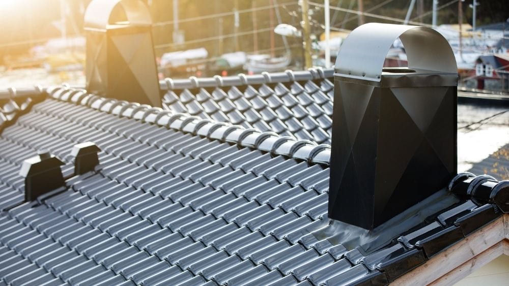 Black ceramic roof with chimneys.