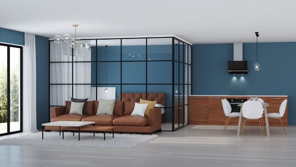 Living room with a bedroom in the back, walled off with glass room dividers.