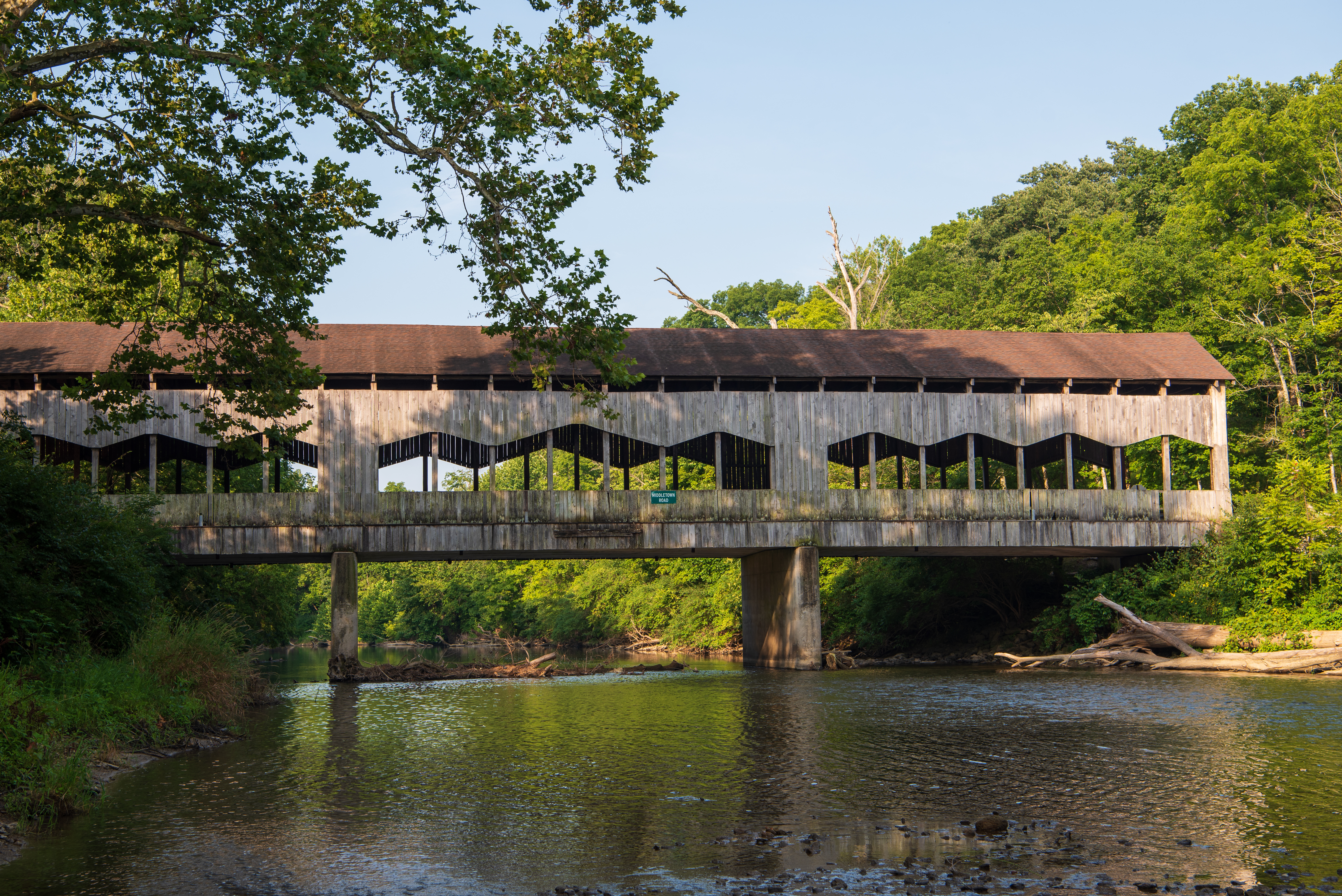 rustic covered bridge over a river