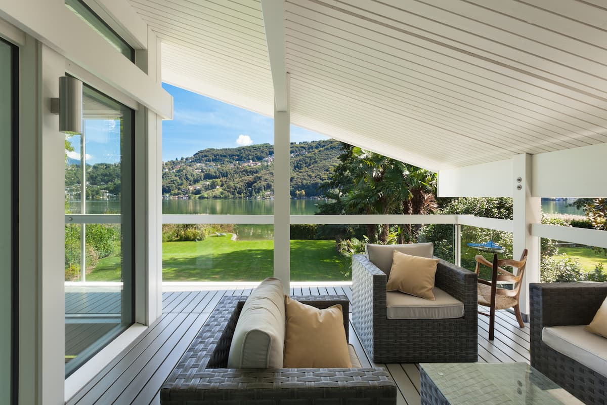 Backyard deck with covered porch, with patio furniture and mountain view in background