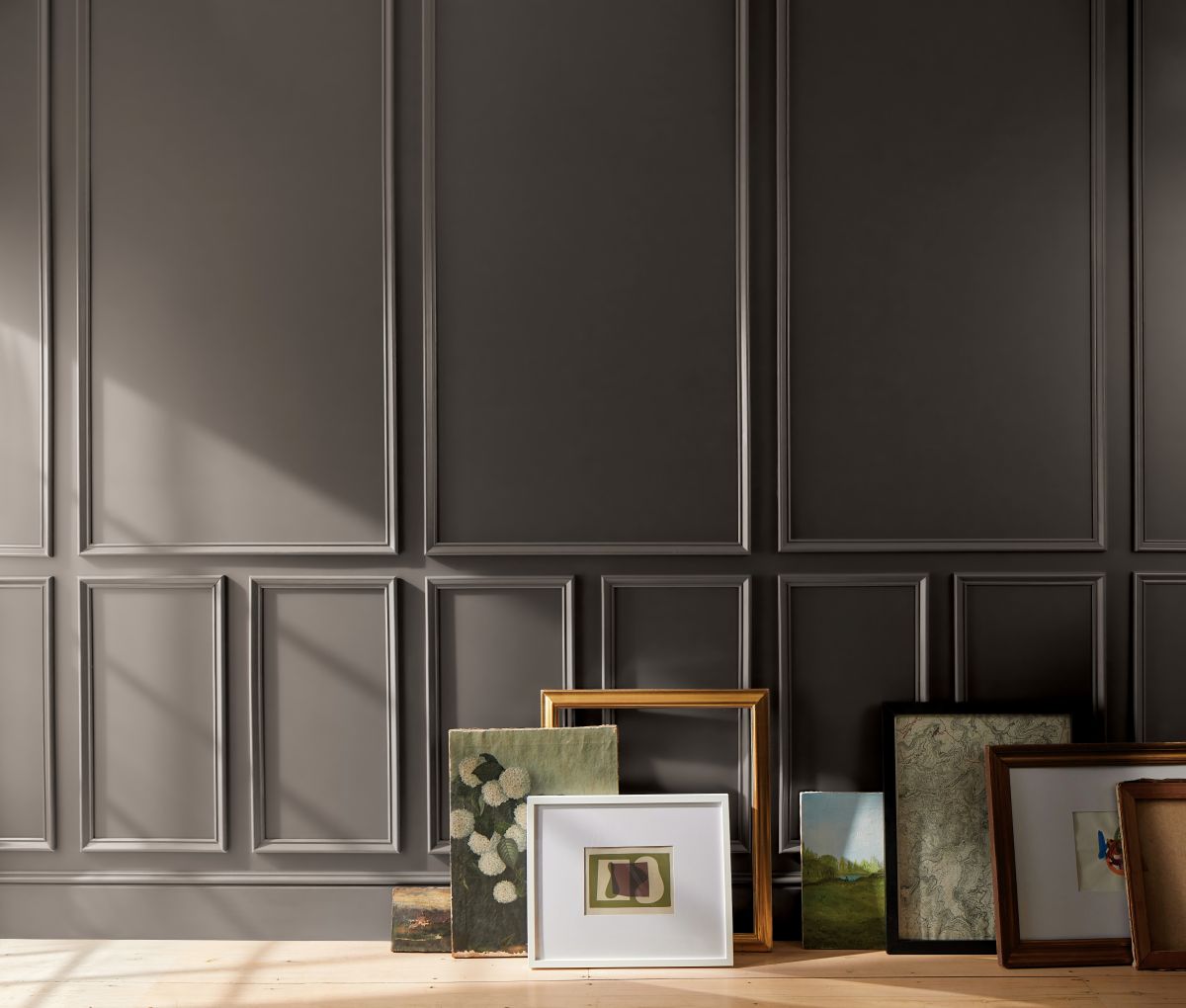 A wall with wood trim accents, painted in Benjamin Moore's choice for Paint Color of the Year for 2026, Silhouette