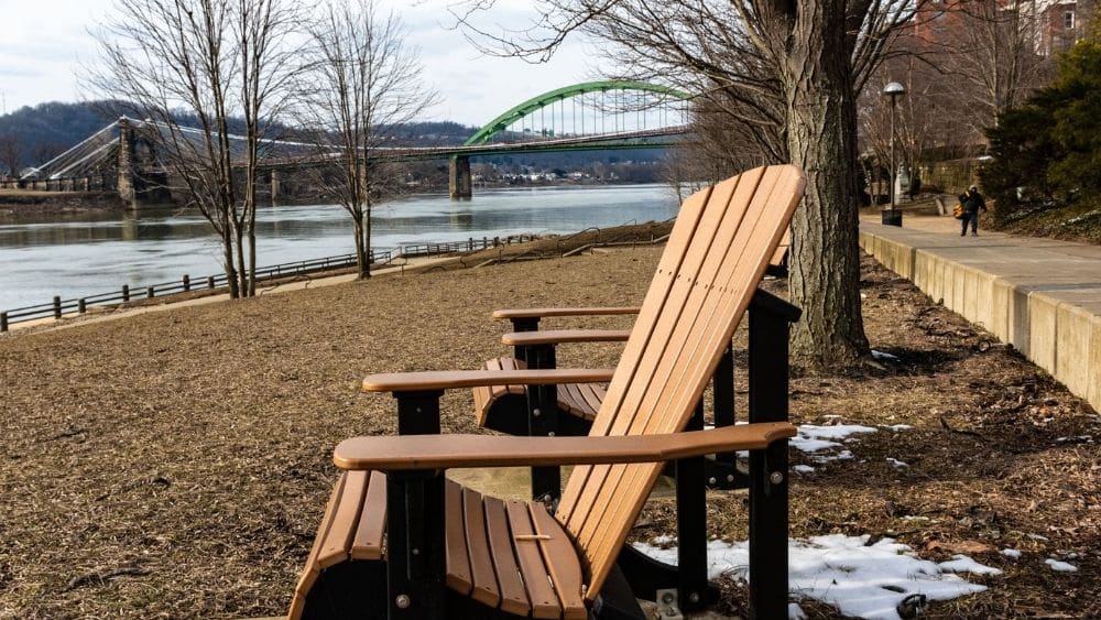 Adirondack chairs on the bank of the Ohio River in Wheeling, West Virginia.