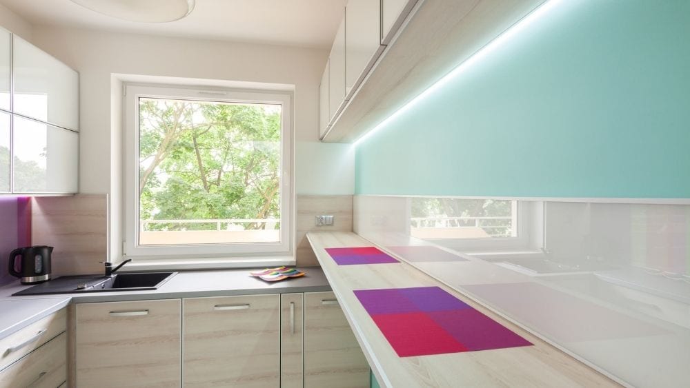 Soft neon under-cabinet lighting in a modern kitchen.