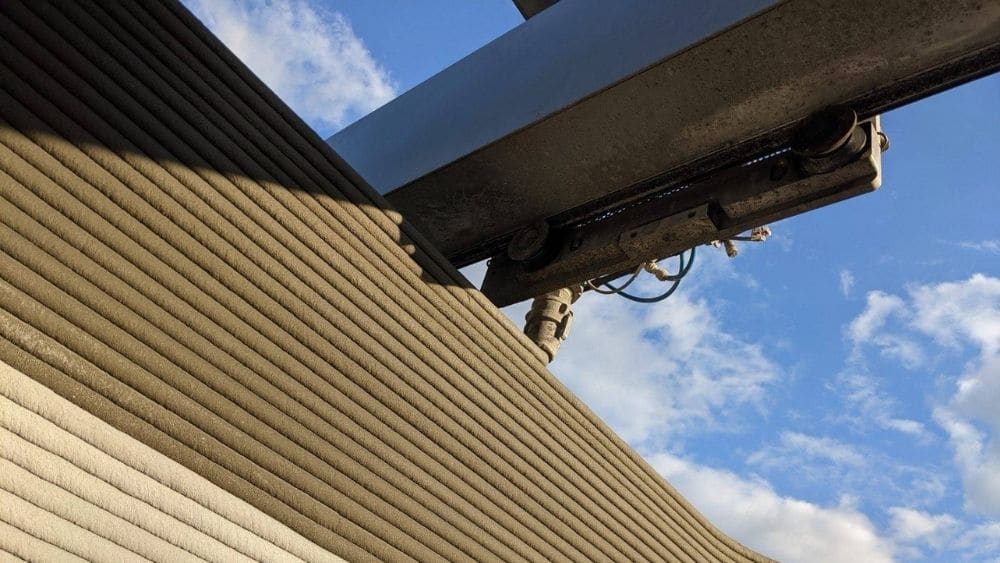 ICON’s 3D home printing machine, printing layers of the exterior walls of a home.