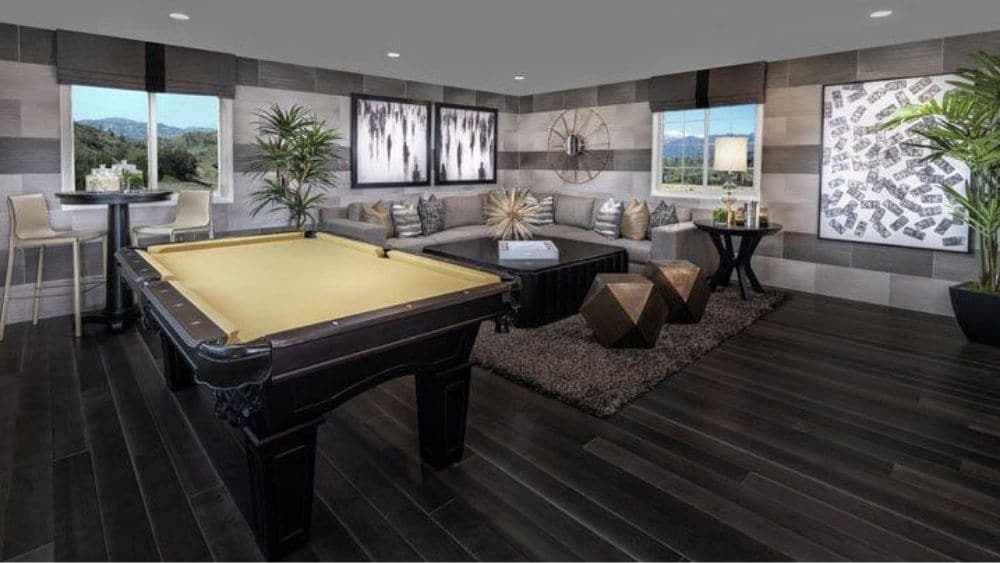 Rendering of a game room with a pool table and ample seating.