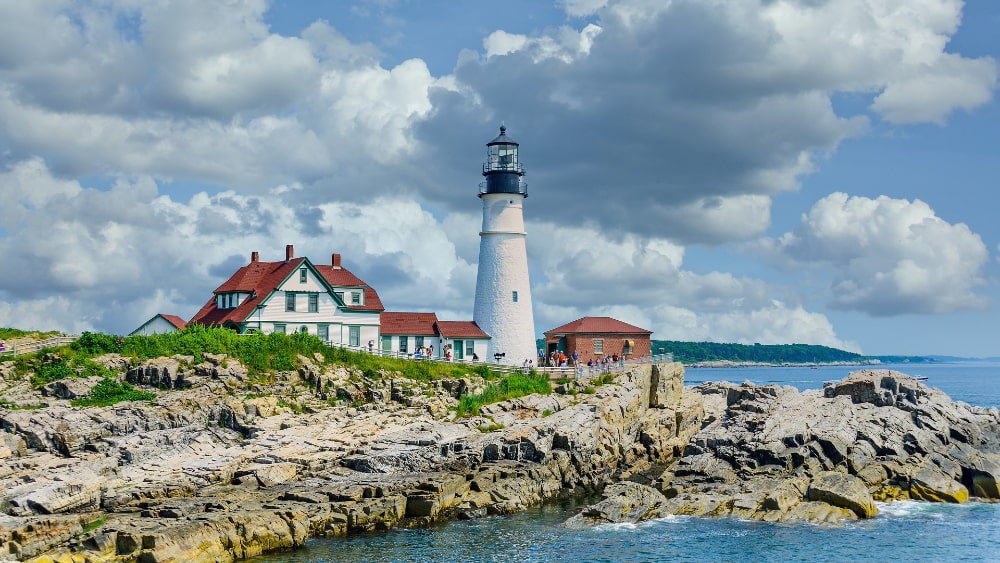 Lighthouse in Maine with clouds in the sky