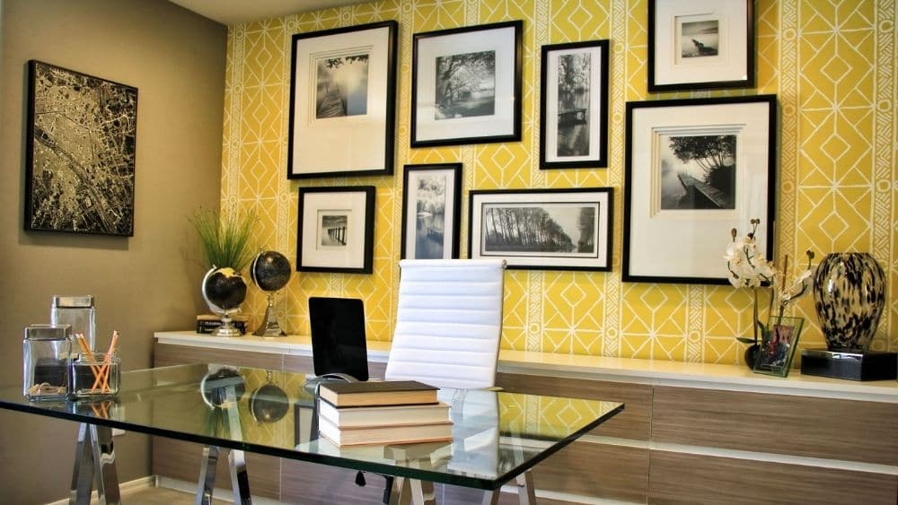 Modern home office with a yellow and white patterned wall.