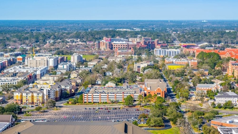 View from above of a city with colorful buildings and lots of trees.