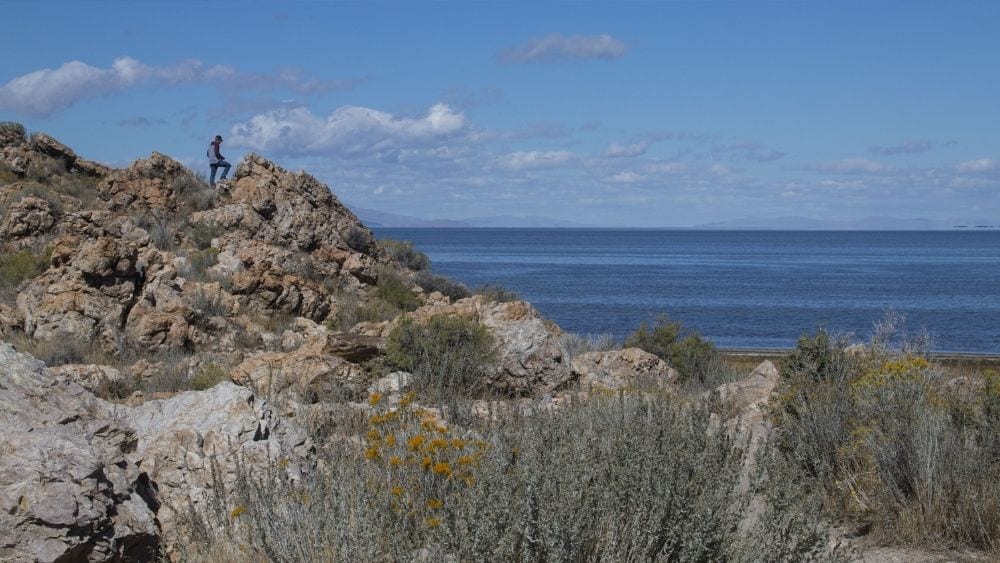 Hiker on the rocks overlooking Salt Lake by Layton City.