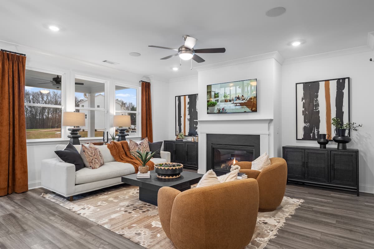 open concept living room with global inspired decor, fireplace and abstract art