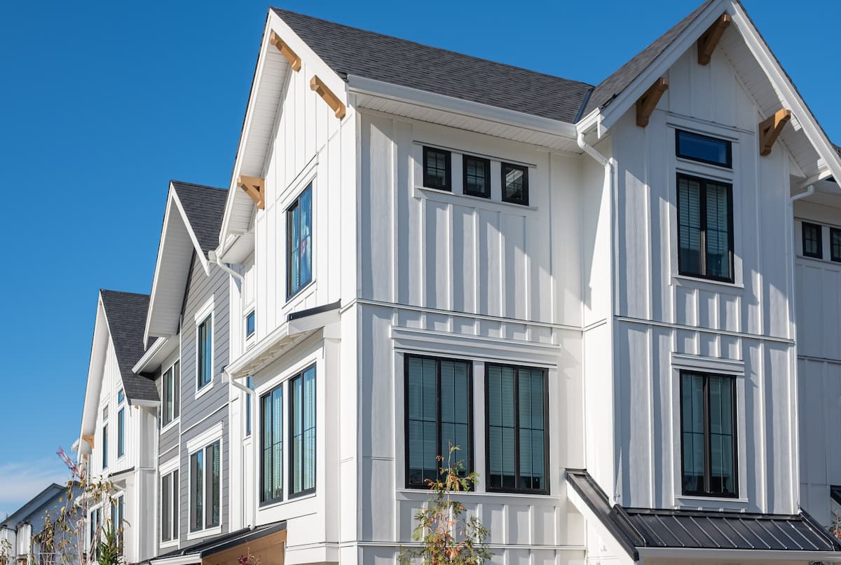 Stacked townhomes with white siding