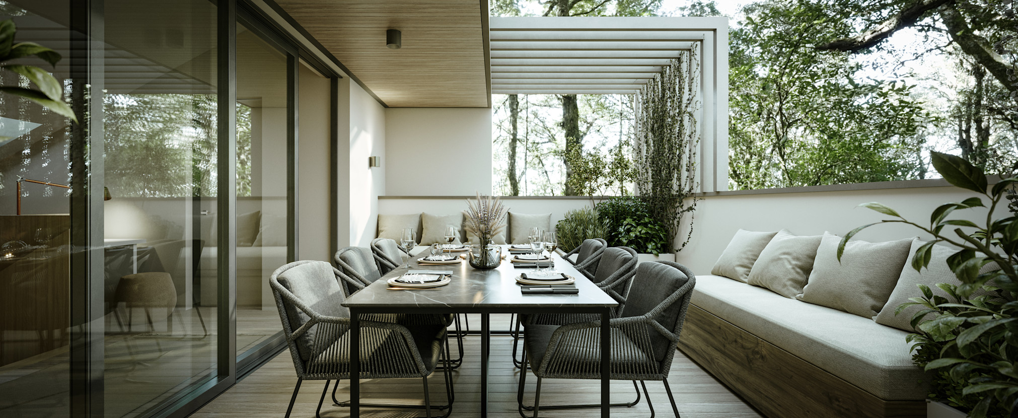 Outdoor dining table with places set and chairs. Built-in banquette seating with cushions, large sliding glass doors and half-wall enclosing the seating area