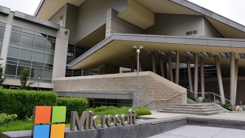 A modern, multi-story building with a sign that reads ‘Microsoft’ with the company logo.