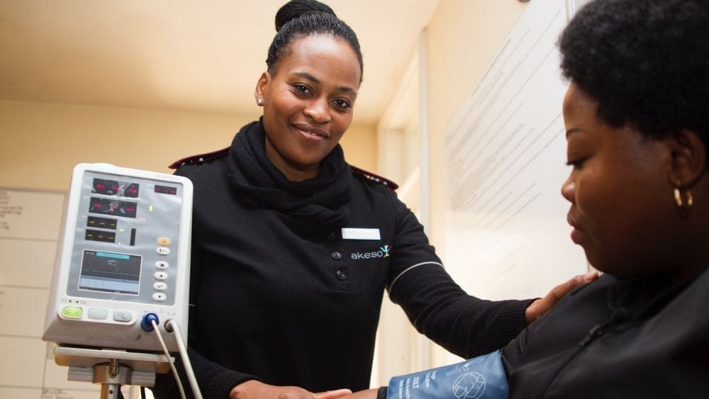 Two women taking blood pressure