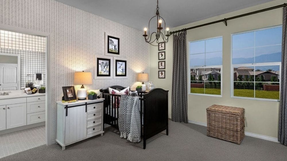A modern nursery with large windows and black and white furniture.