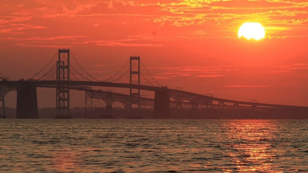 A bridge over the water at sunset.
