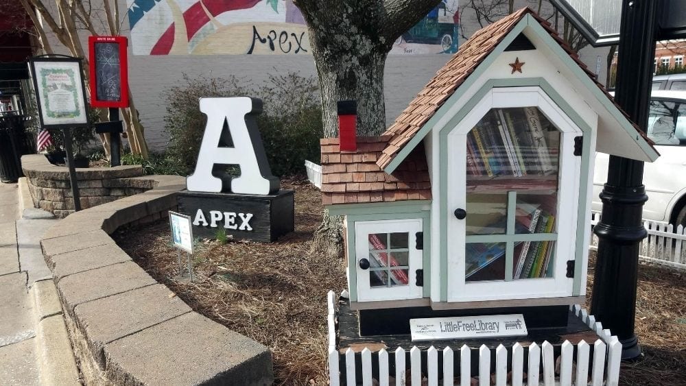 A Little Free Library. an “A” and a mural that reads “Apex.”