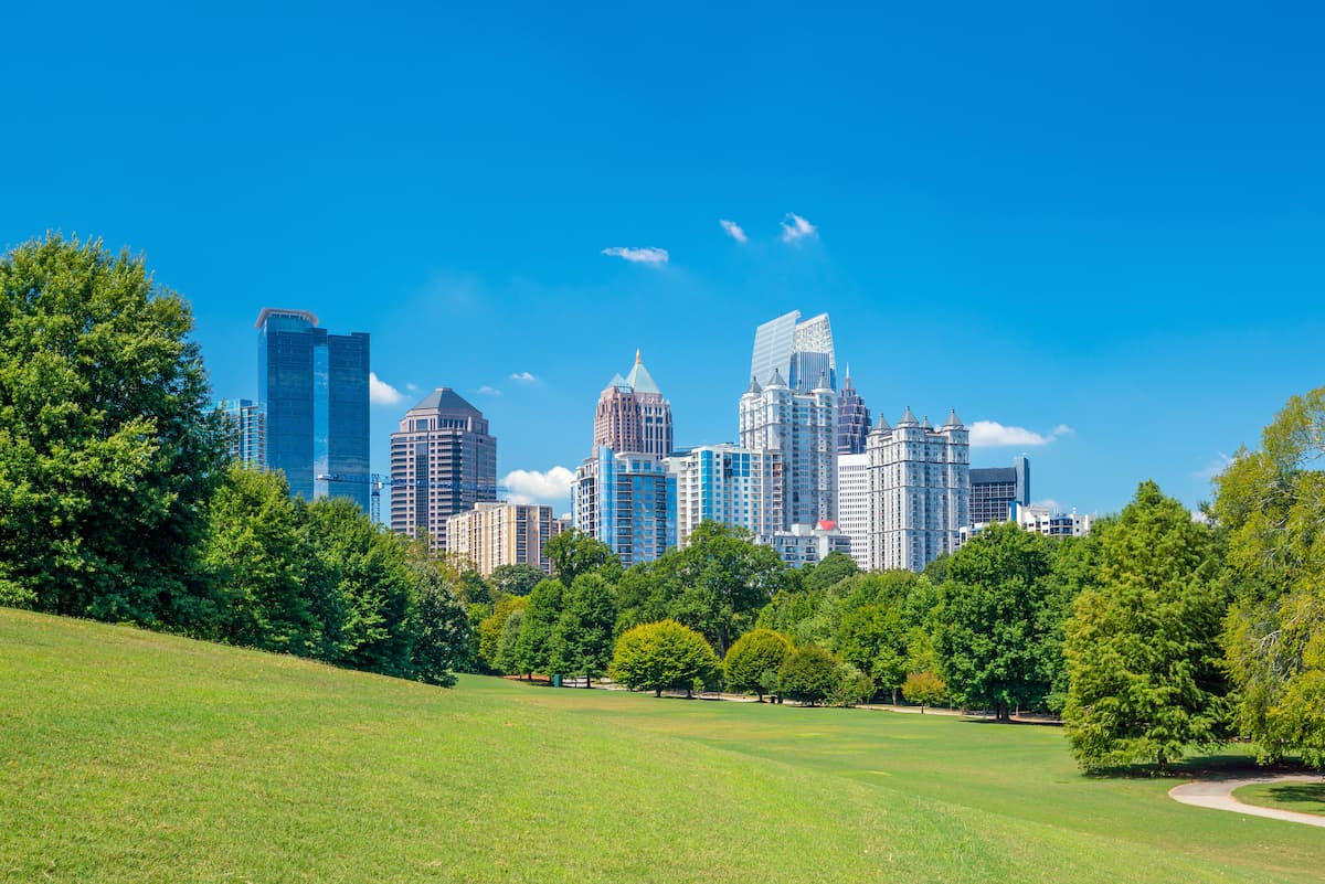 grassy hill in park overlooking skyscrapers
