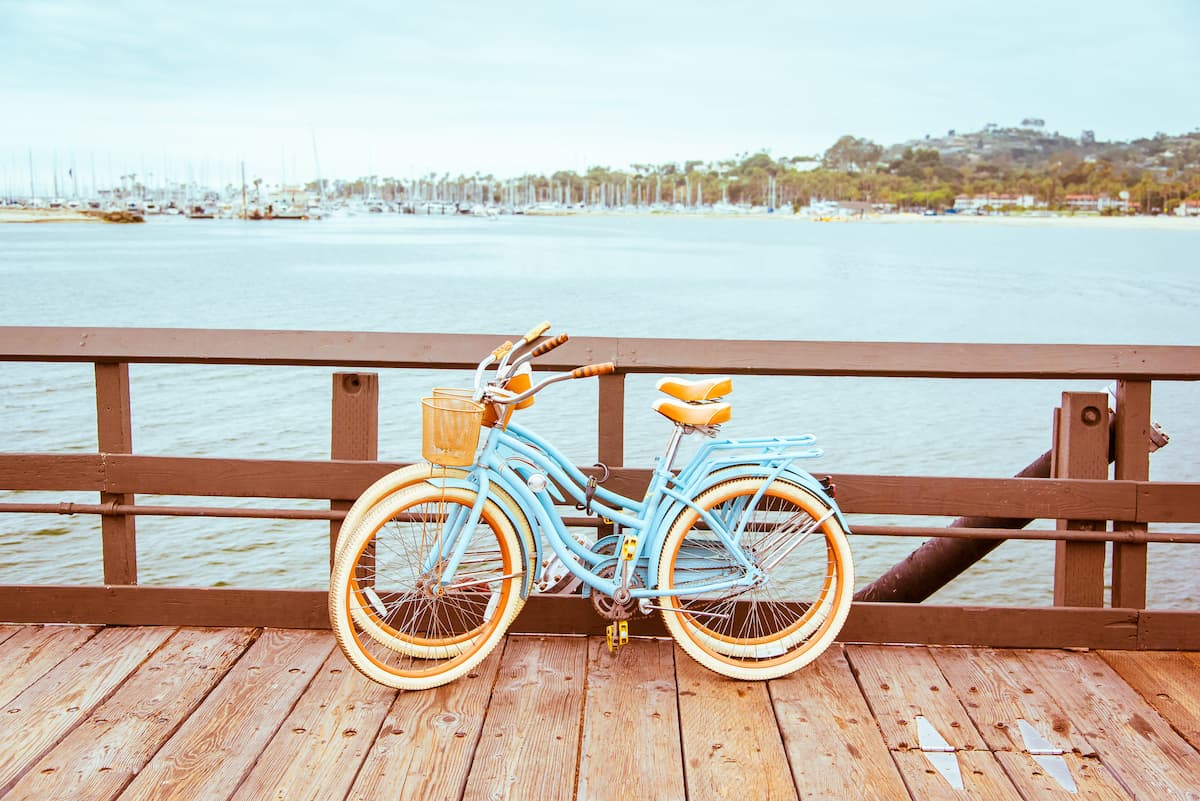 vintage bikes resting against pier overlooking water