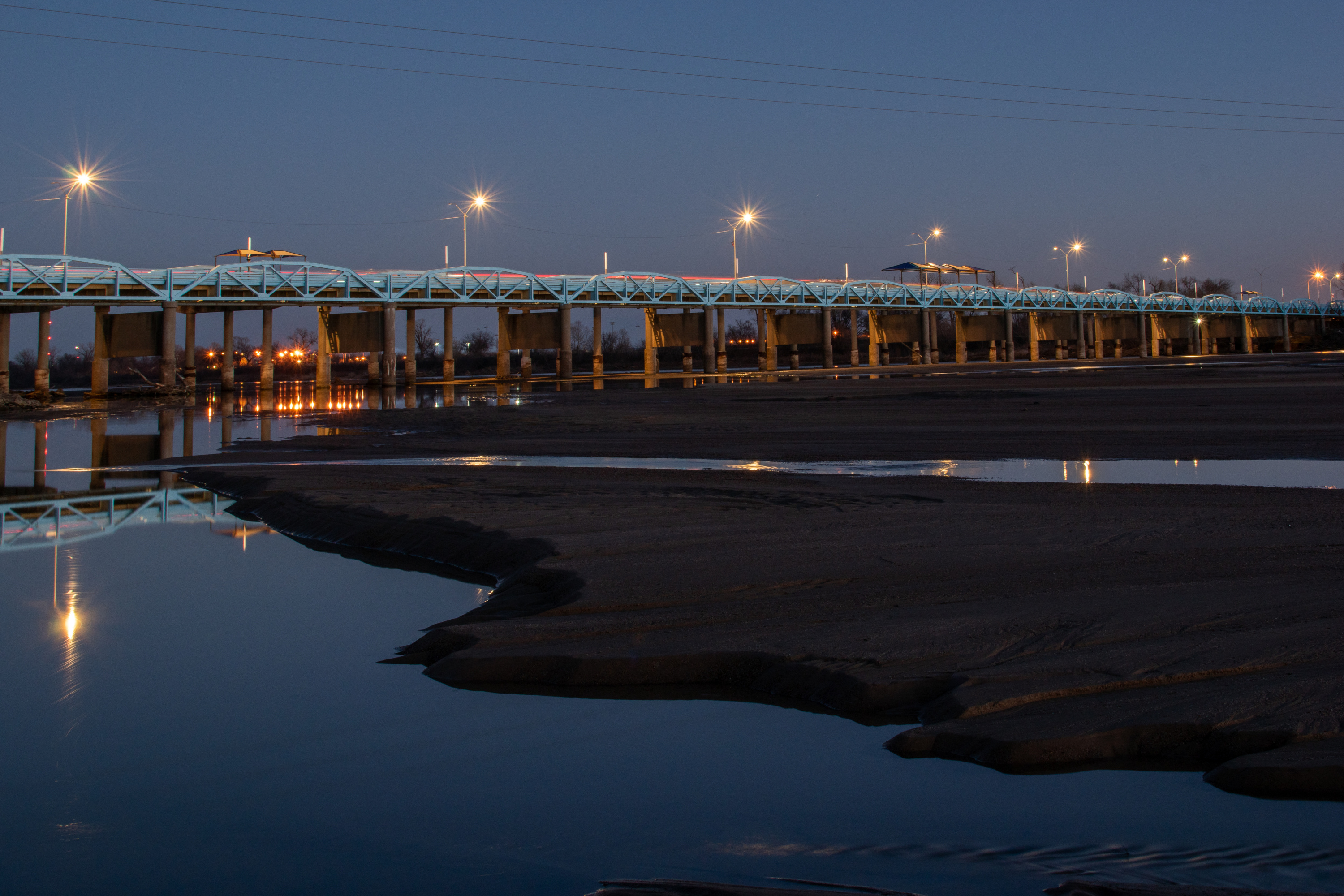 large bridge spanning water at night