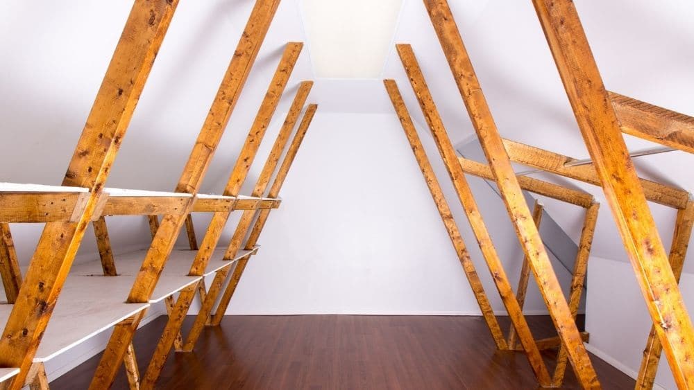 Unfinished attic with designated storage space.
