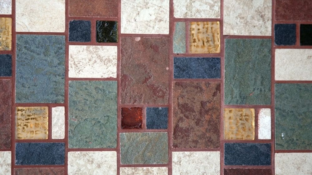 Colorful tile with red grout.