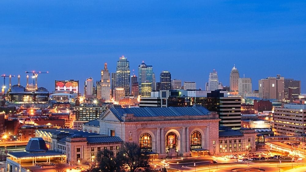 Kansas City at night, lit up with city lights.