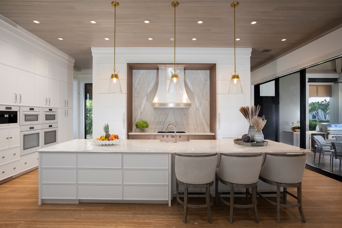 Transitional-style kitchen with built-in seating, pendant lighting and range hood