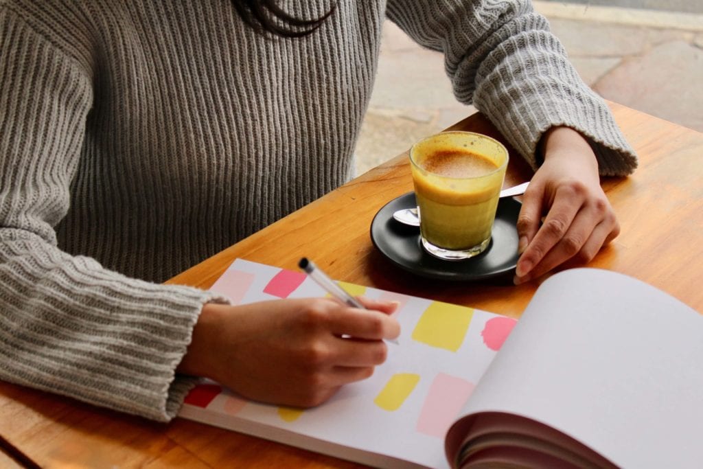 Woman planning at table with notebook