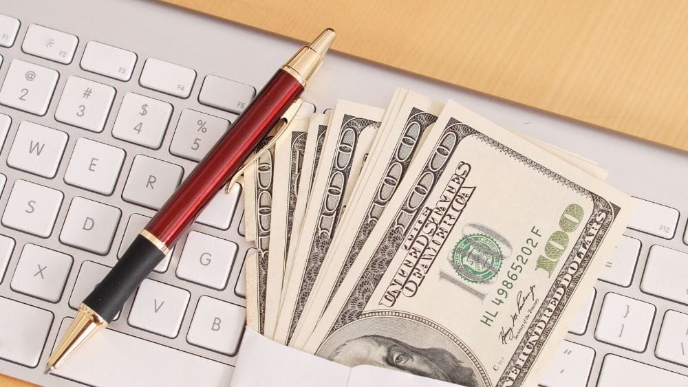 cash money on top of a keyboard