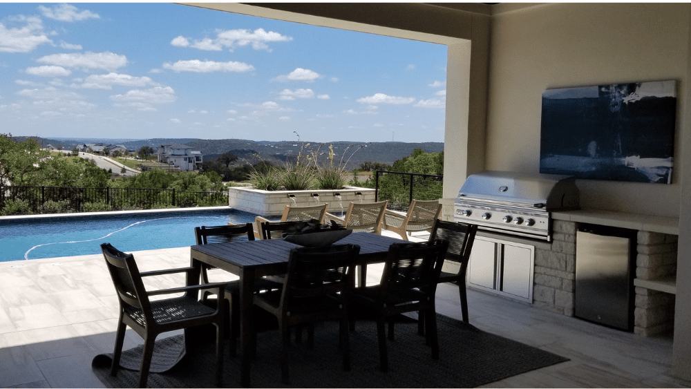 The outdoor kitchen, patio, and pool area at one of the Taylor Morrison model homes at the Travisso community.