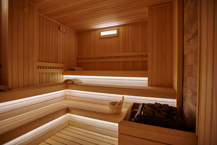 Benches in a cedar wood sauna with hot rocks 