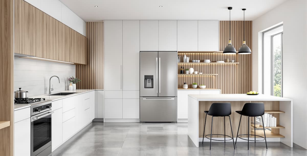 Two-tone kitchen cabinetry, flat panel with wood and white finishes, in a kitchen with an island and stainless steel appliances