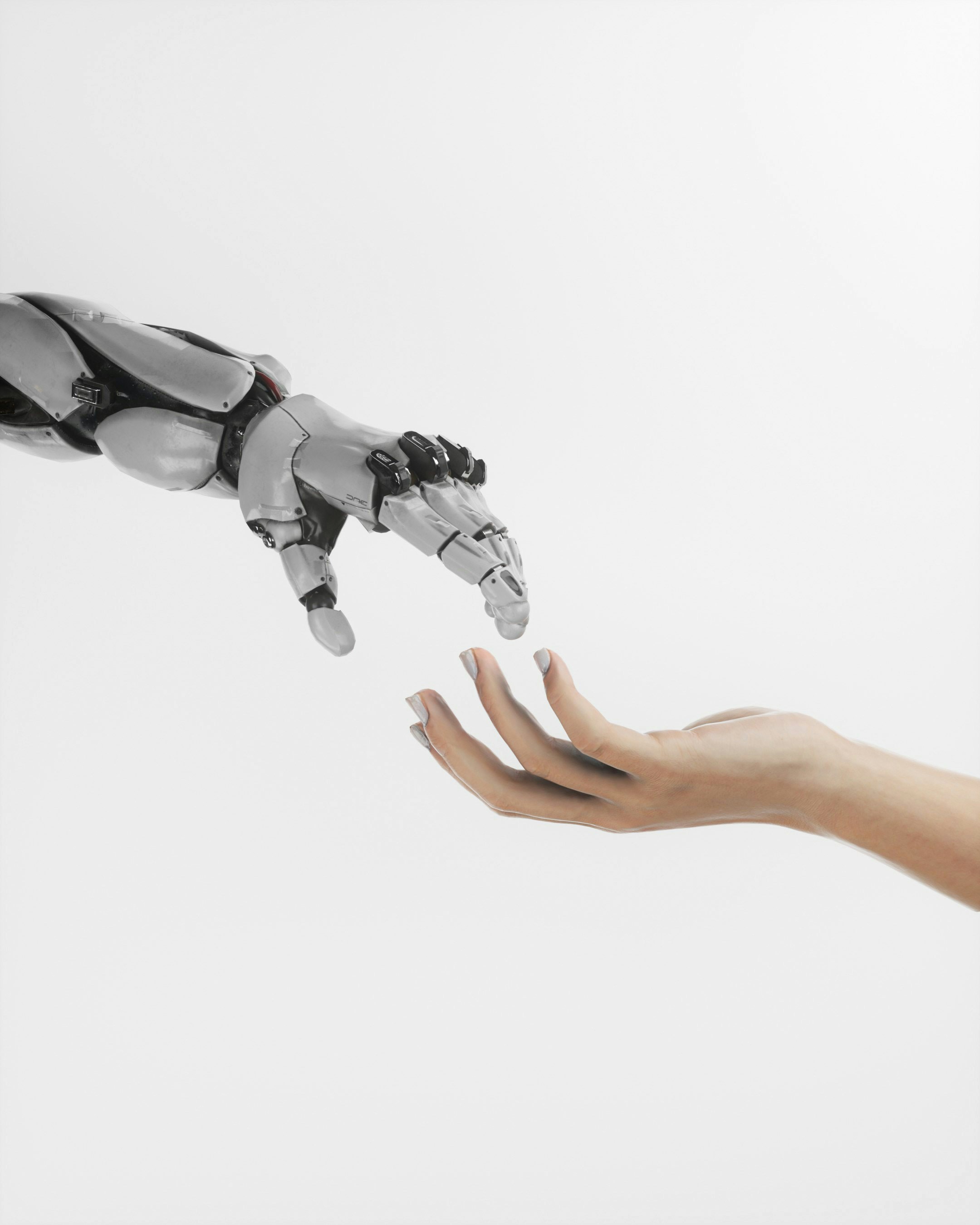A robotic hand reaching out to a human hand.