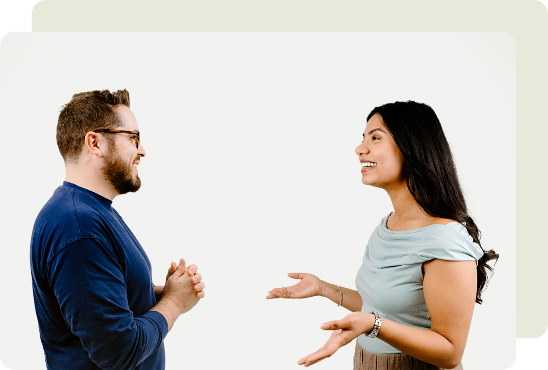 Two colleagues talking to each other face to face.