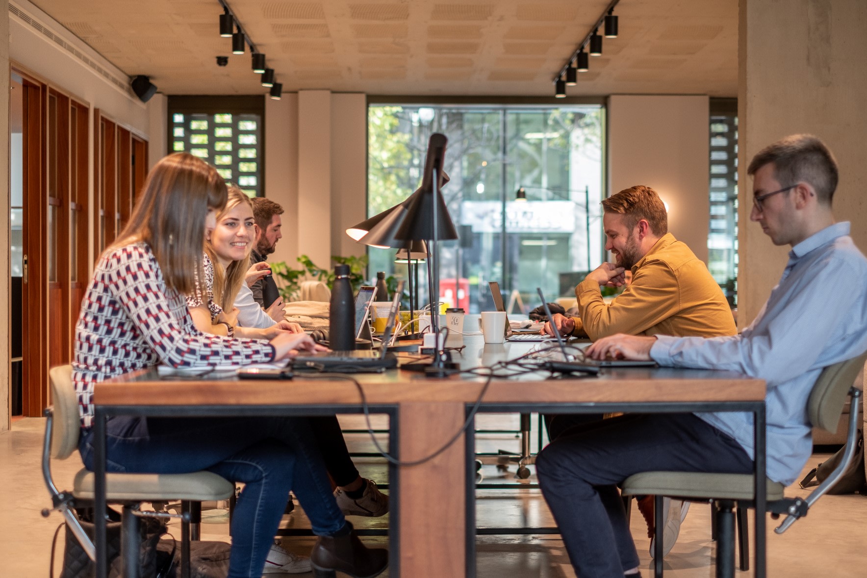 A team of colleagues working around a desk.