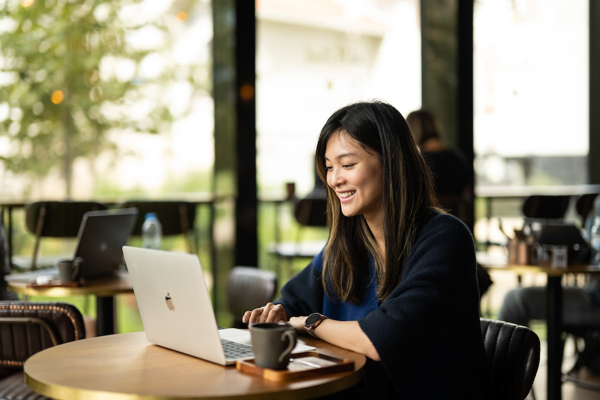A woman working at her desk studying the 70:20:10 development model