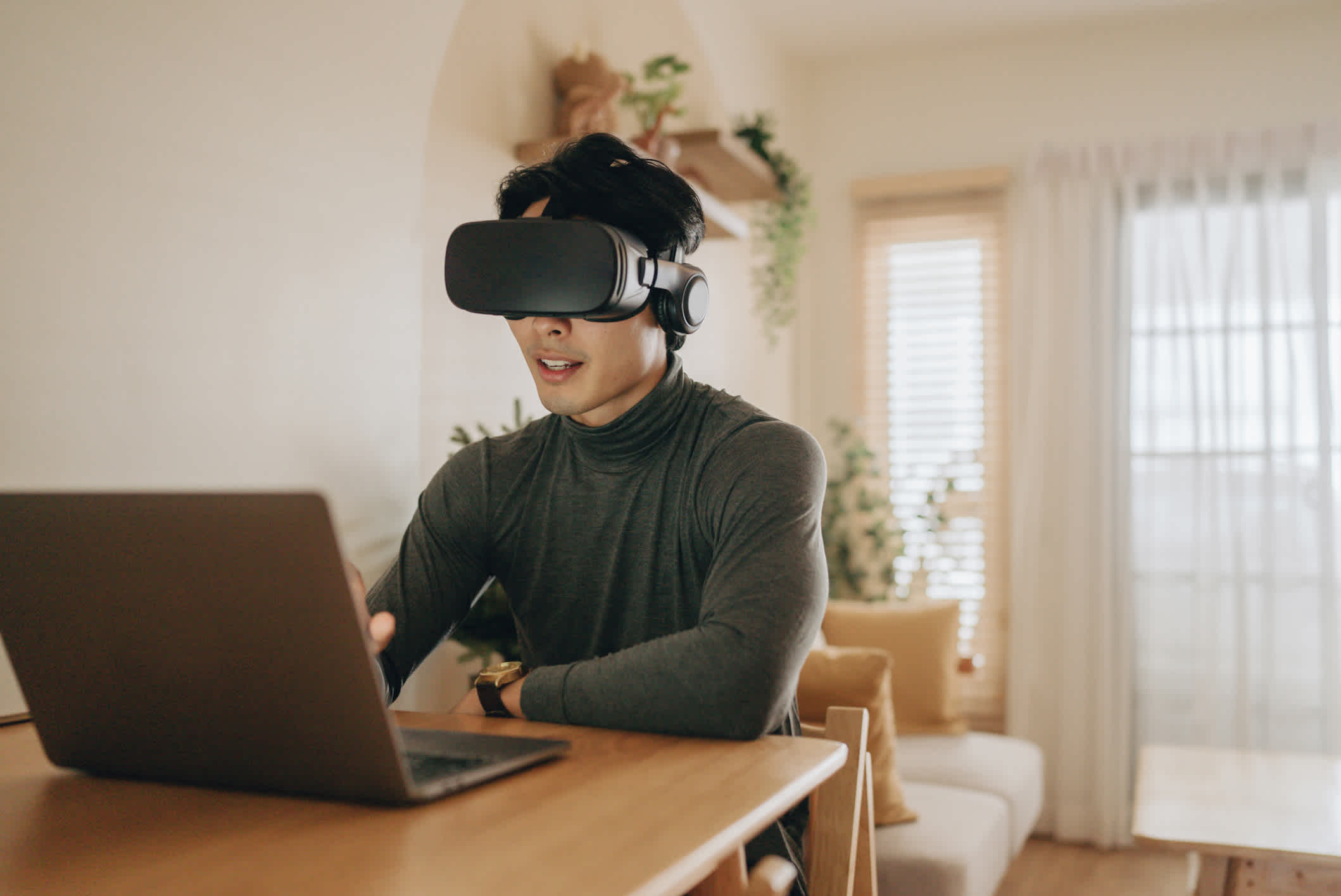 Young asian man enjoy playing virtual reality simulator for relaxation in living room at home

