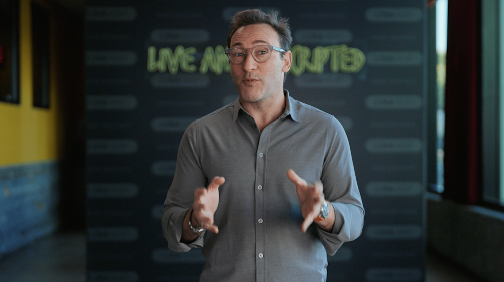 Photo of Simon Sinek speaking with quote from a Healthcare worker who was a Gift of Coaching participant: "I feel more balanced in the skills I learned and also encouraged to know I have support in a challenging career field."