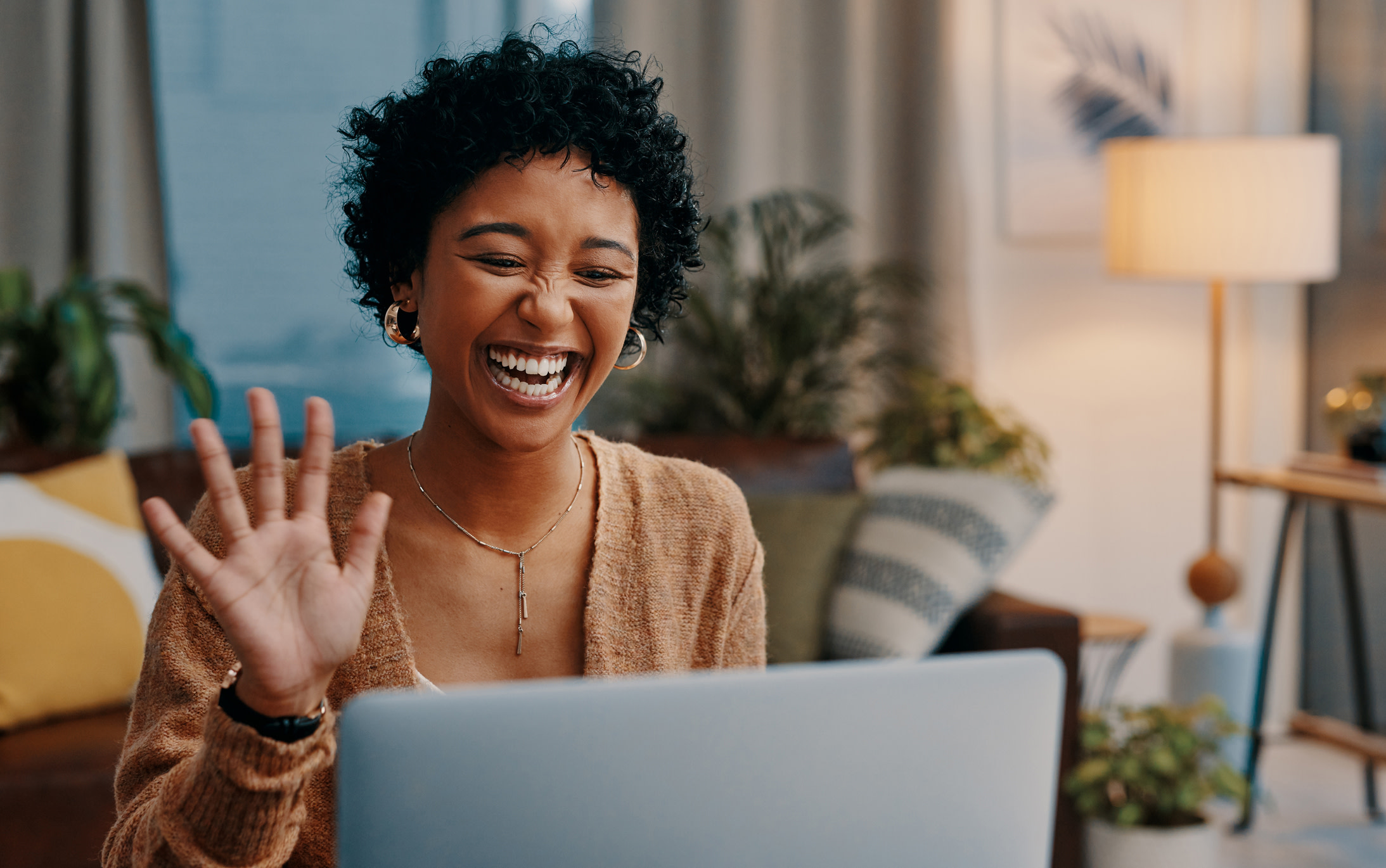 Femme très joyeuse faisant signe à son ordinateur portable