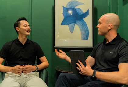 Two men having a discussion during a leadership coaching session.