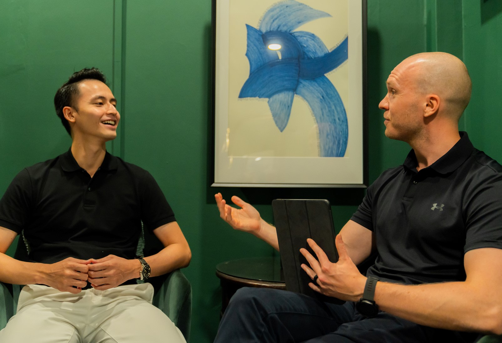 Two men having a discussion during a leadership coaching session.