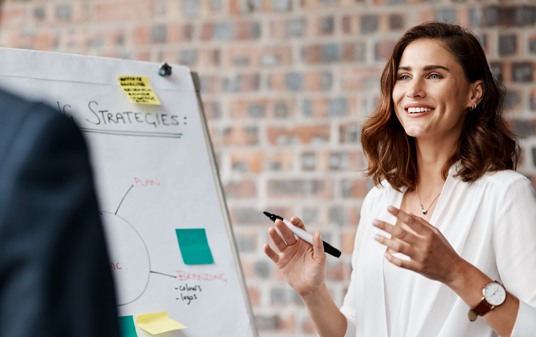 Woman smiling and presenting.