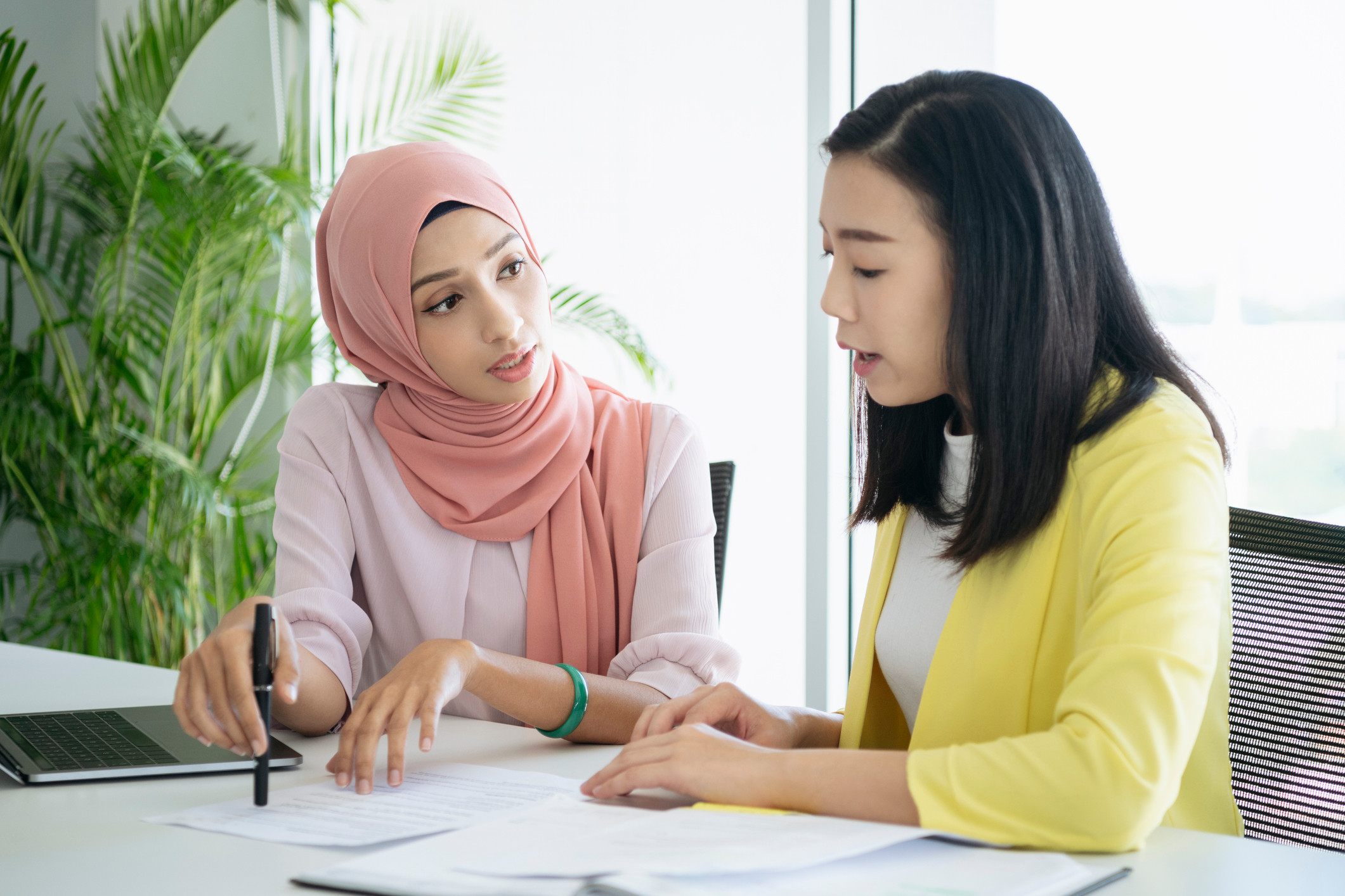 Two women having a discussion at work