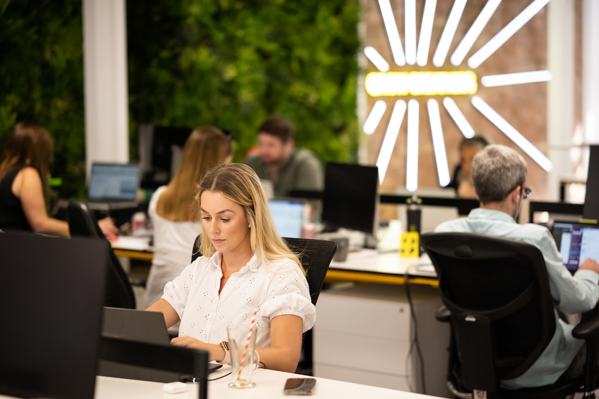 People working on computers in the EZRA office