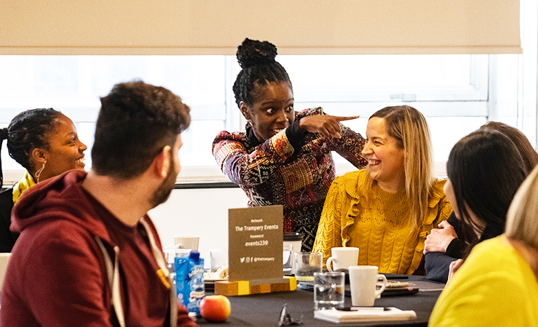 A woman wearing a head scarf smiling. 